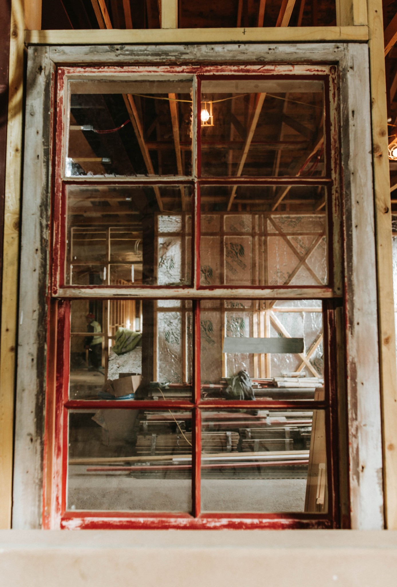 Image of the a window looking in to the Old Royal Station where building work is taking place