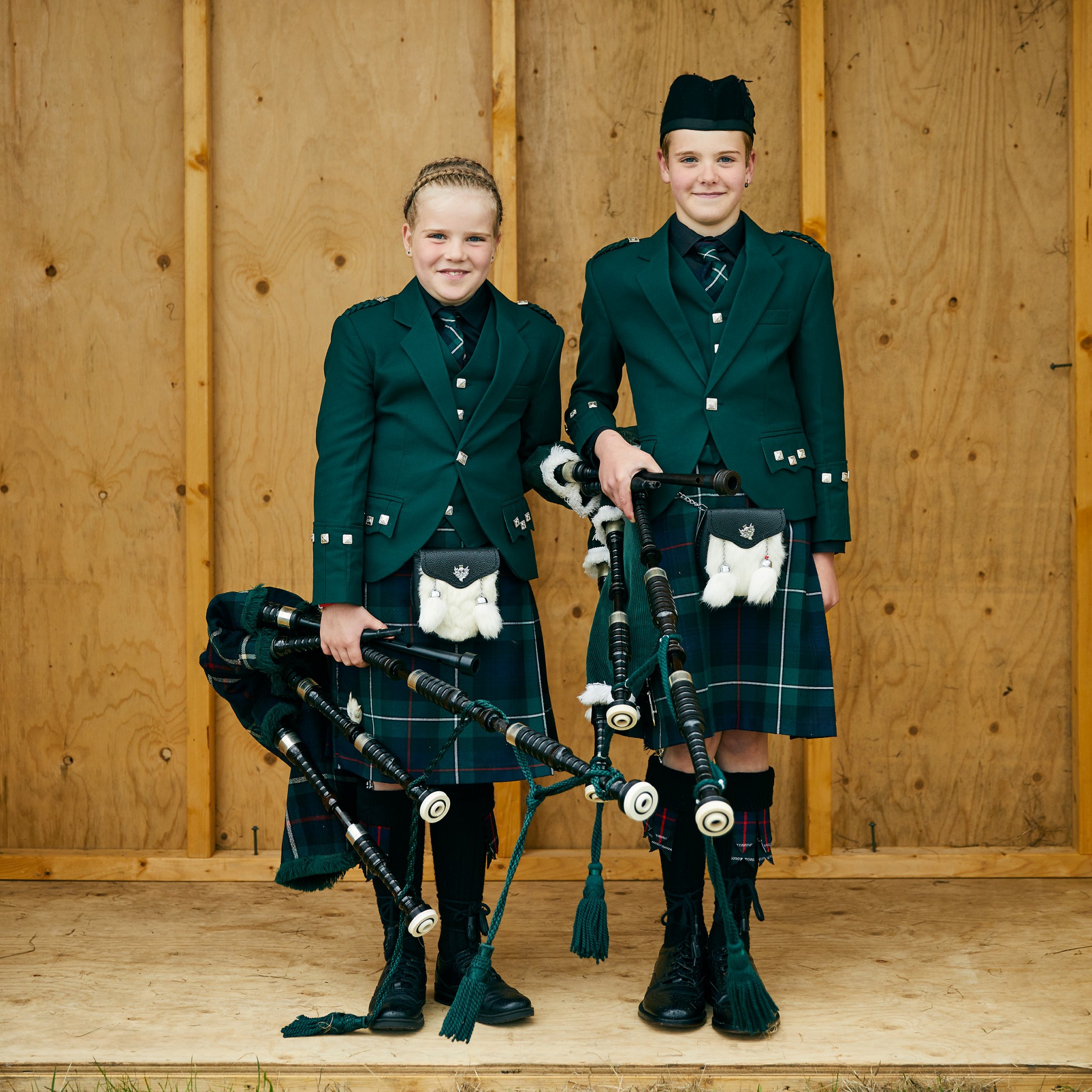 Image of two girls wearing kilts and holding bag pipes