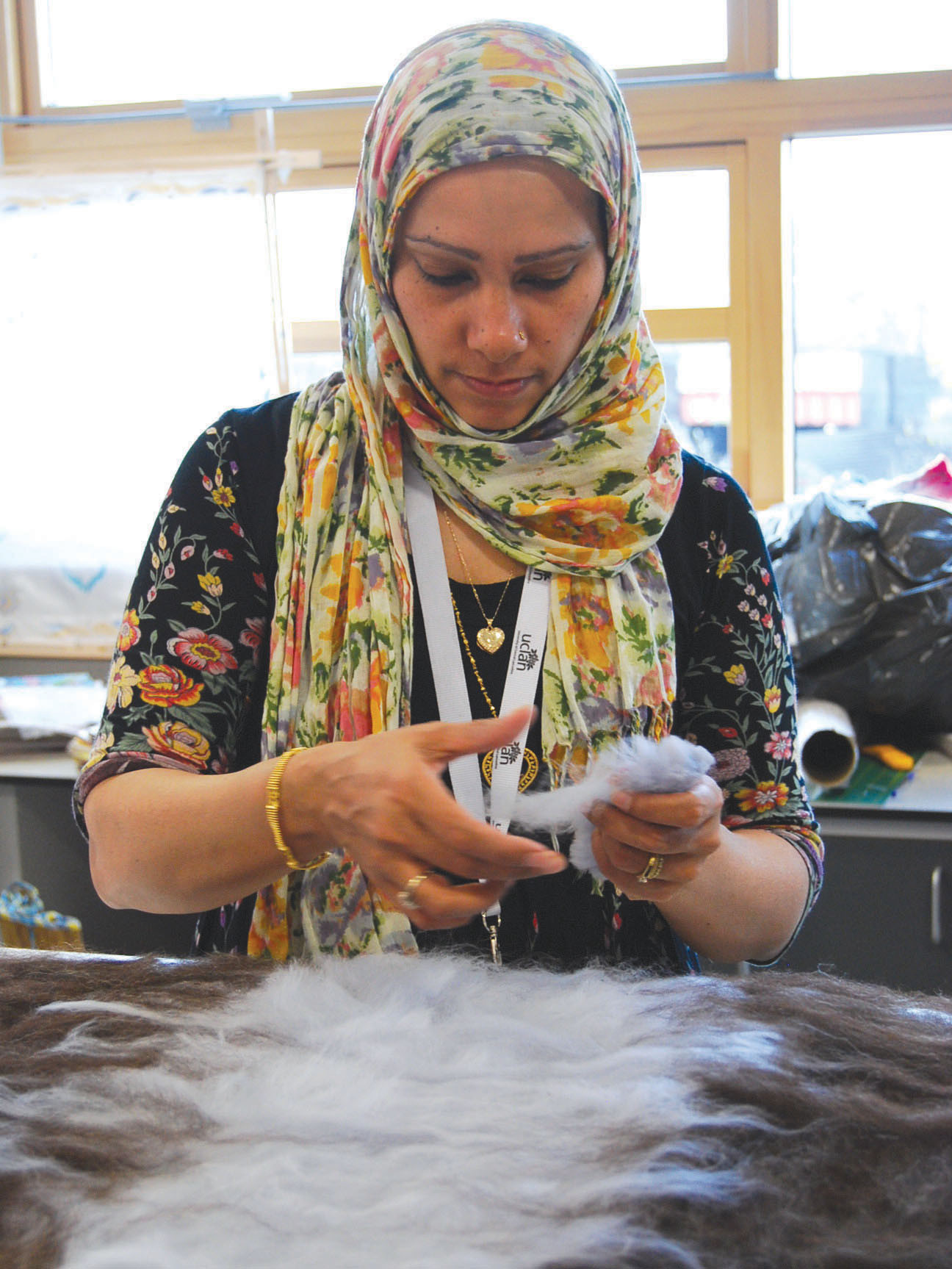 An image of a women holding wool