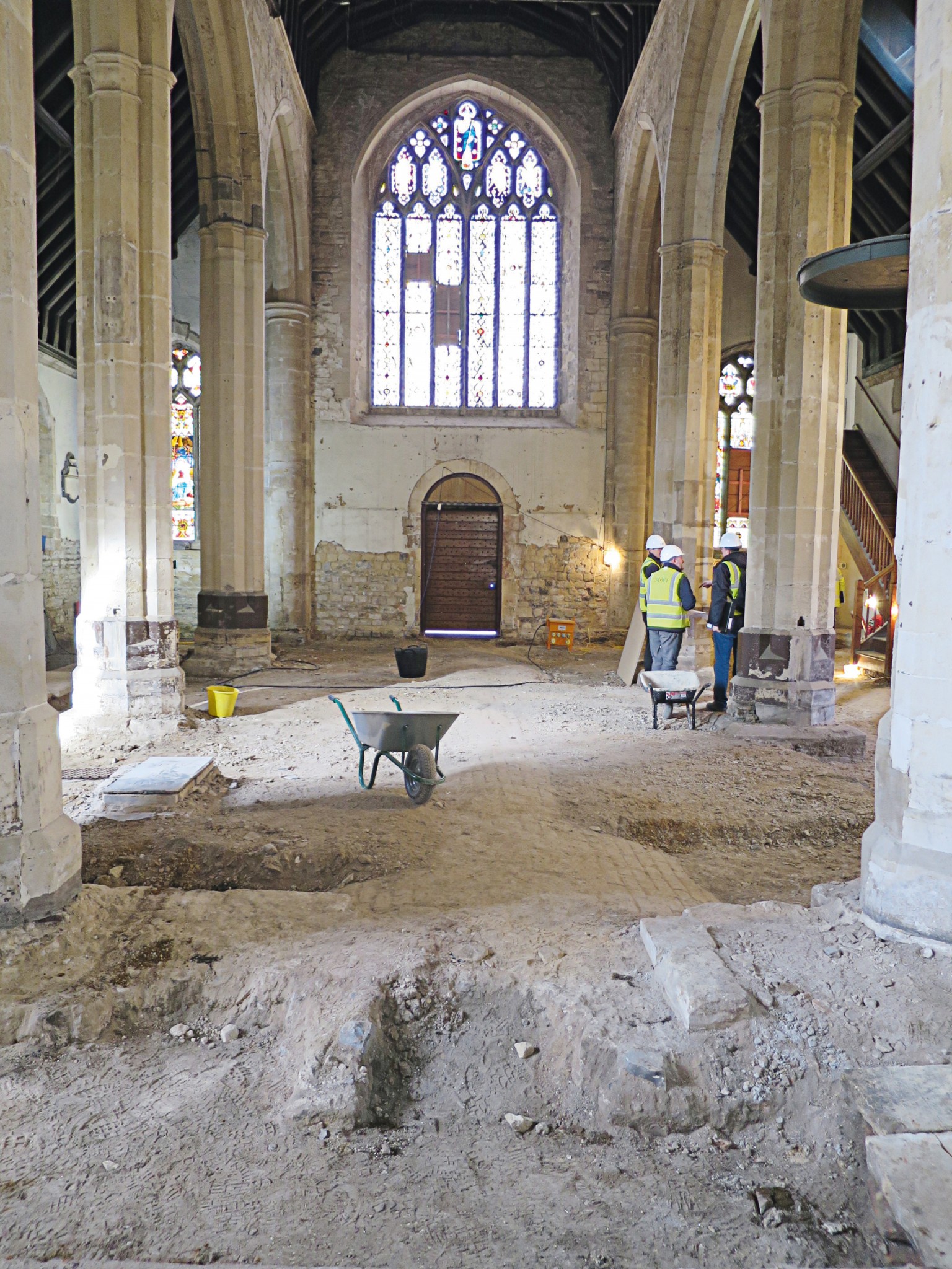 Image of the church interior with three builders talking