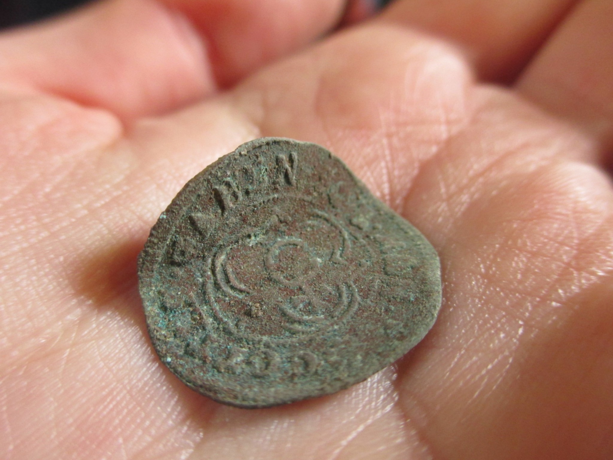 Image of closeup of a hand holding a relic